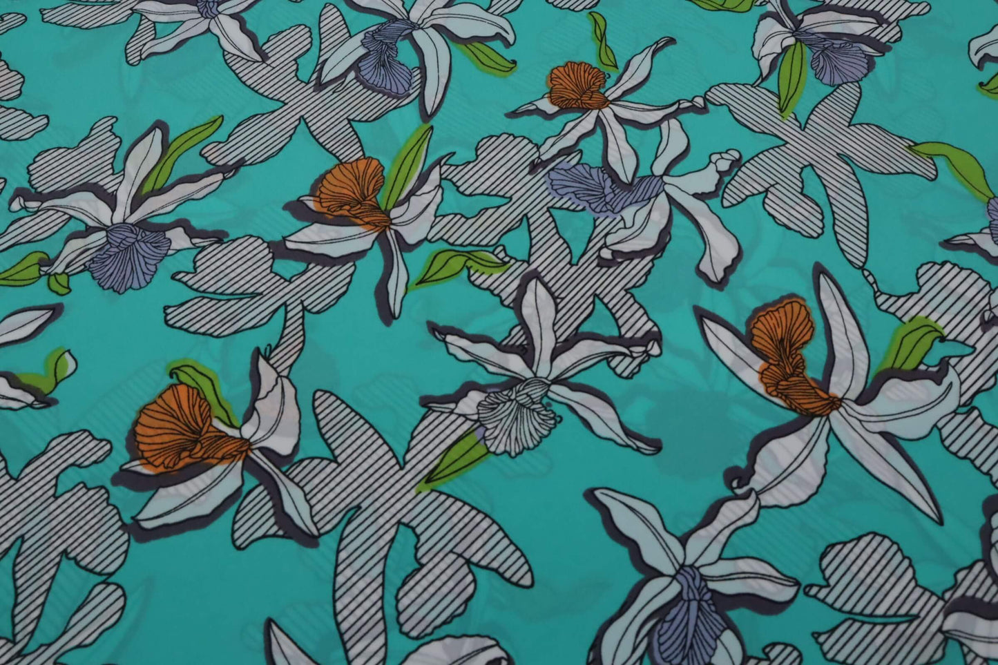 Green blue polyester crepe fabric with tropical flower print