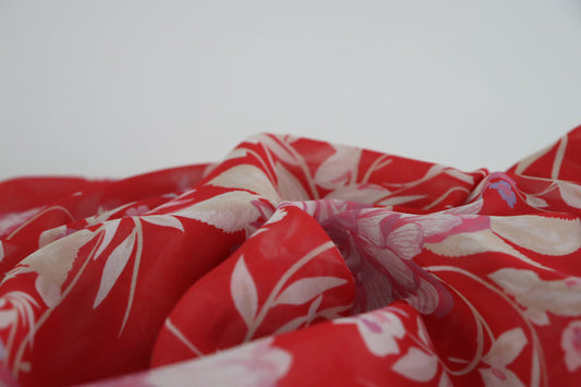 Tissu mousseline de polyester  imprimé fleurs blanche sur fond rouge